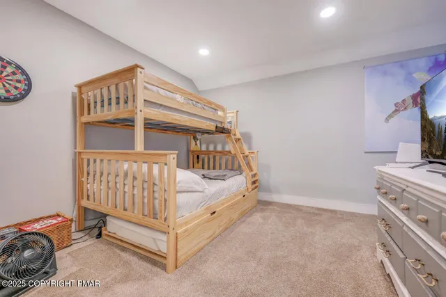 a view of a bedroom with baby bed and a window
