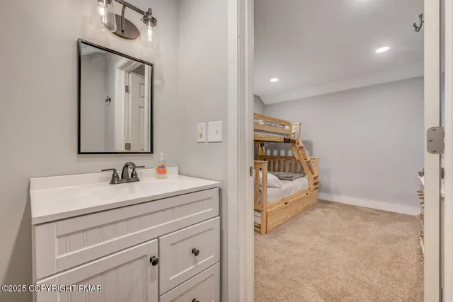 a bathroom with a sink a toilet and mirror