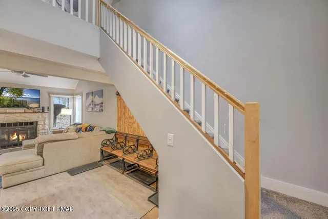 a view of staircase with railing and a window