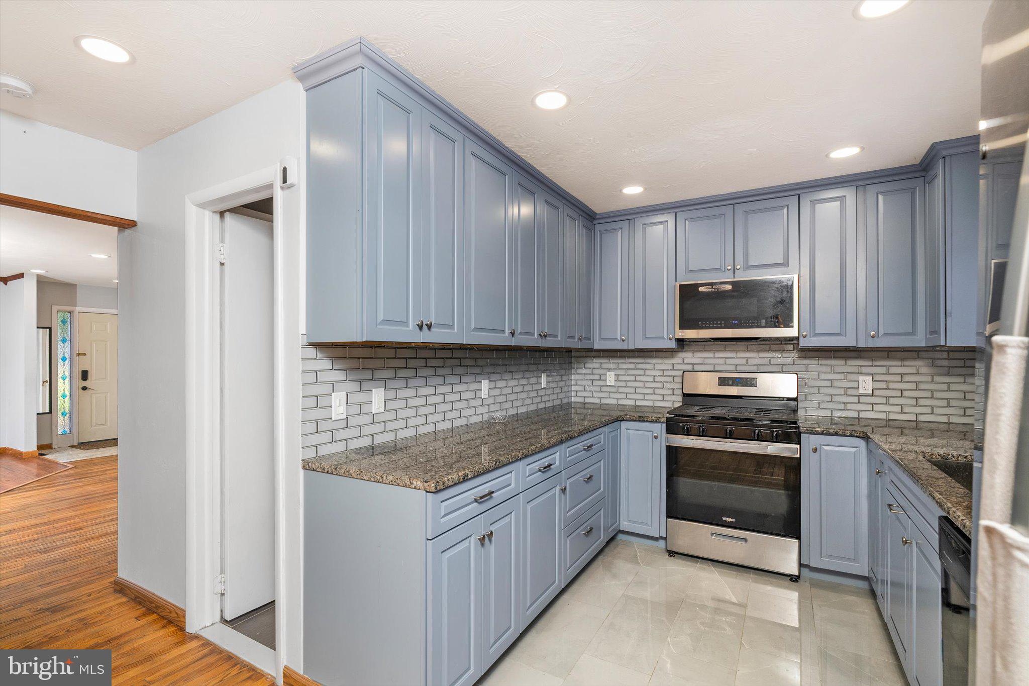 234 Probasco Road East Windsor, NJ 08520 - Photo 11 of 25 a kitchen with stainless steel appliances granite countertop wooden cabinets a stove top oven a sink and dishwasher