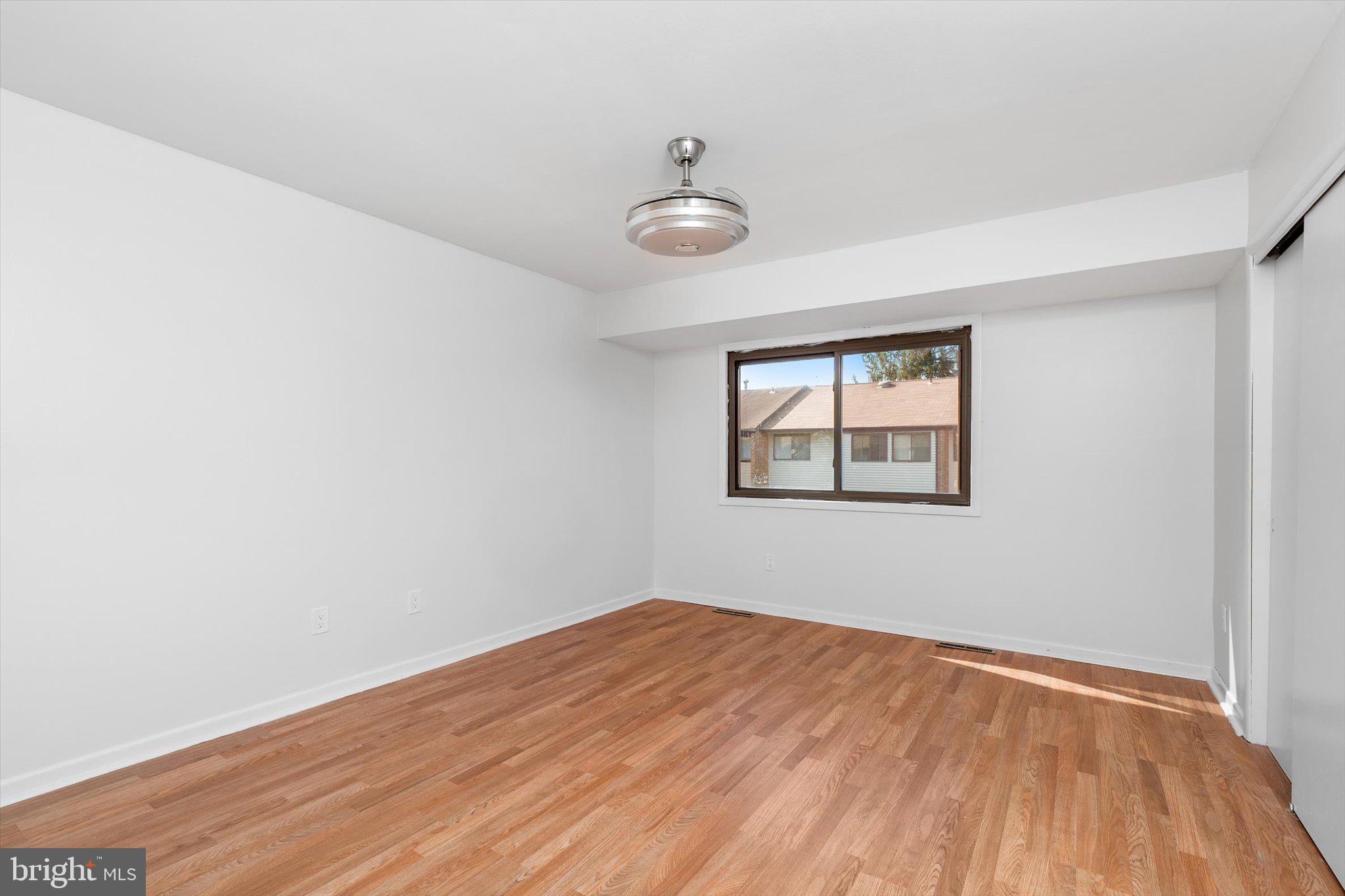 234 Probasco Road East Windsor, NJ 08520 - Photo 14 of 25 an empty room with wooden floor and windows