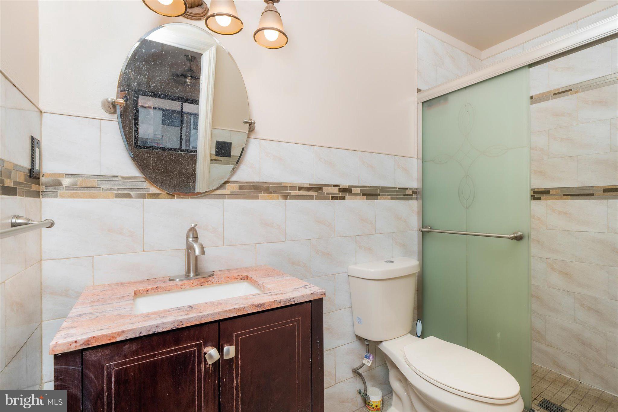234 Probasco Road East Windsor, NJ 08520 - Photo 16 of 25 a bathroom with a granite countertop toilet sink and mirror