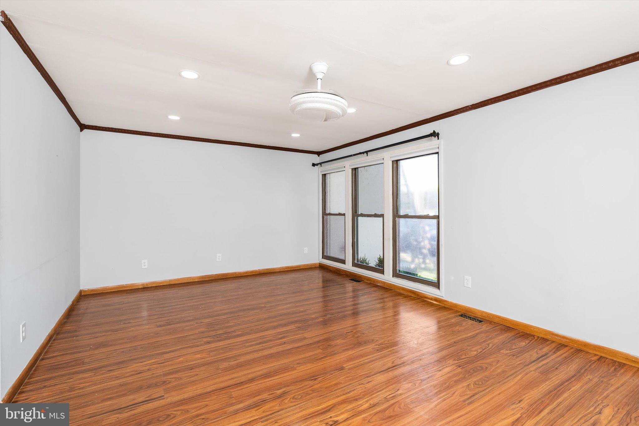 234 Probasco Road East Windsor, NJ 08520 - Photo 4 of 25 a view of an empty room with wooden floor and a window