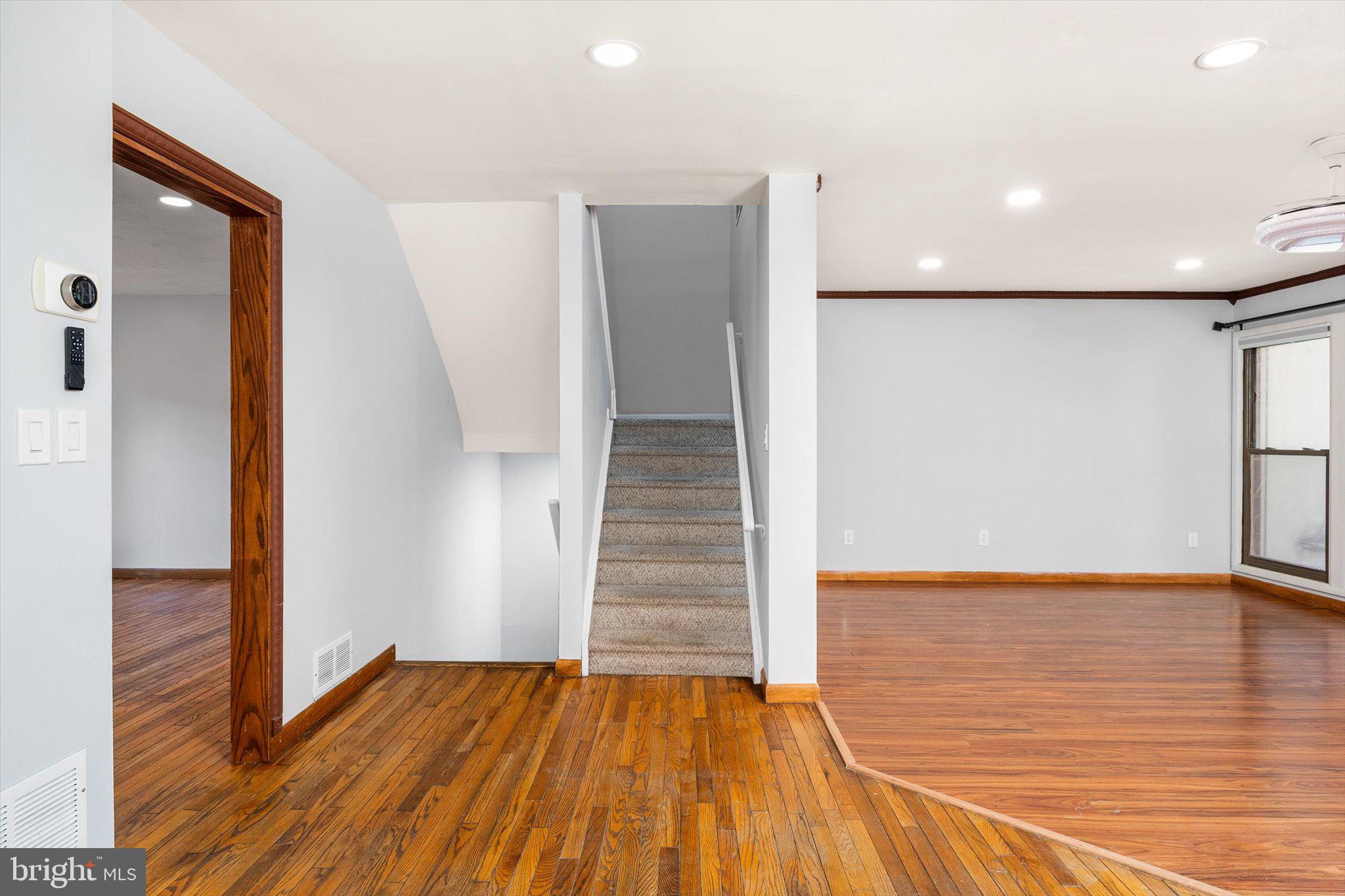 234 Probasco Road East Windsor, NJ 08520 - Photo 7 of 25 a view of empty room with wooden floor and stairs