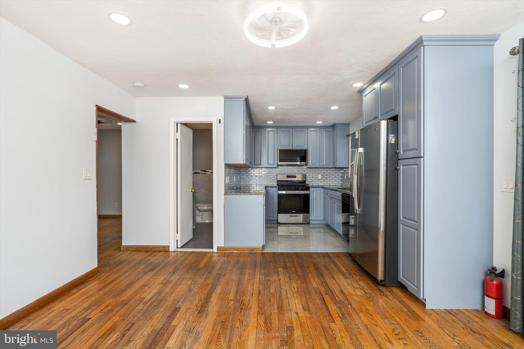 234 Probasco Road East Windsor, NJ 08520 - Photo 9 of 25 a kitchen with stainless steel appliances a refrigerator and a wooden floor