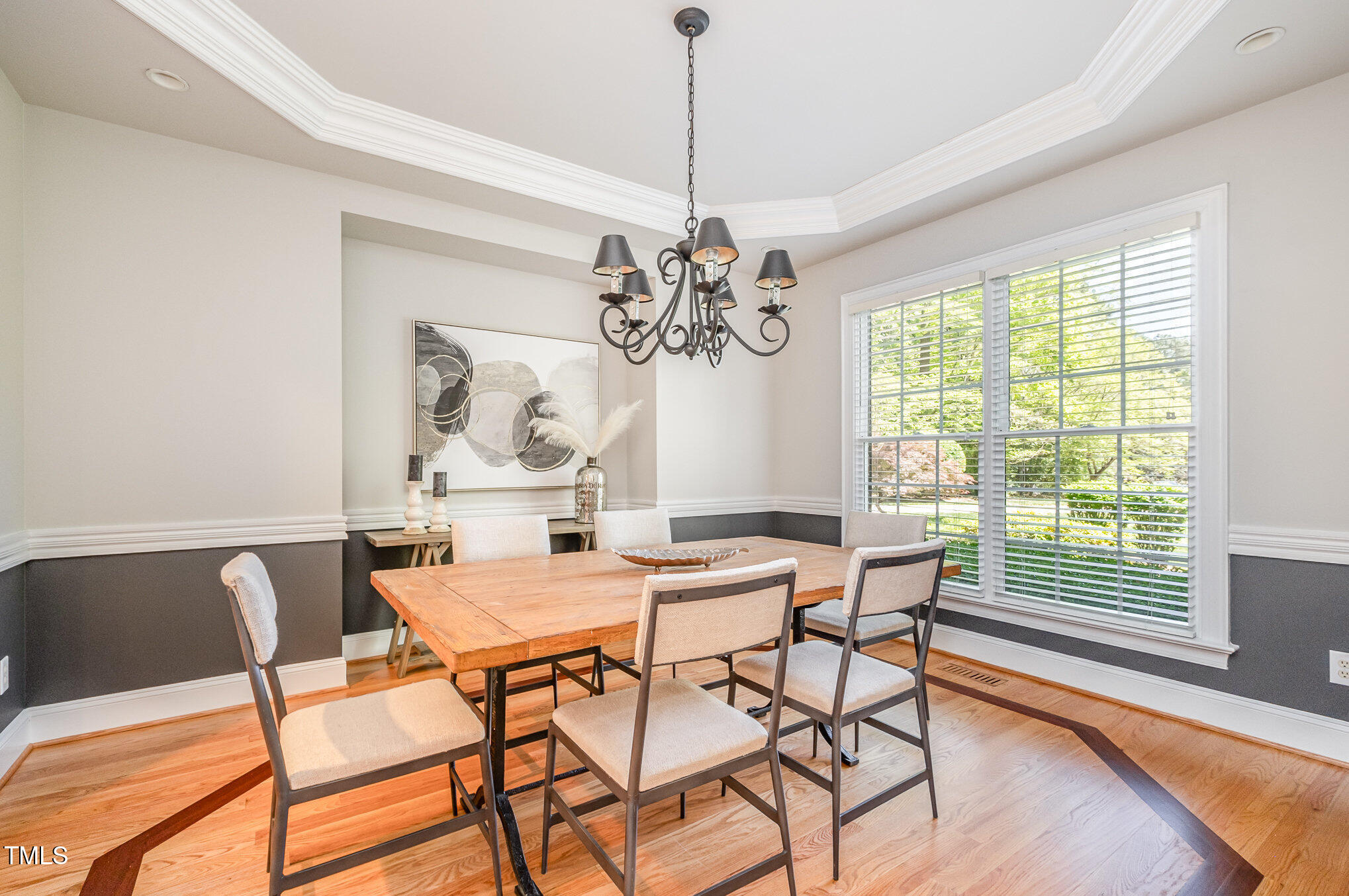 5912 Weather Rock Court Raleigh, NC 27613 - Photo 14 of 50 a view of a dining room with furniture a chandelier and wooden floor