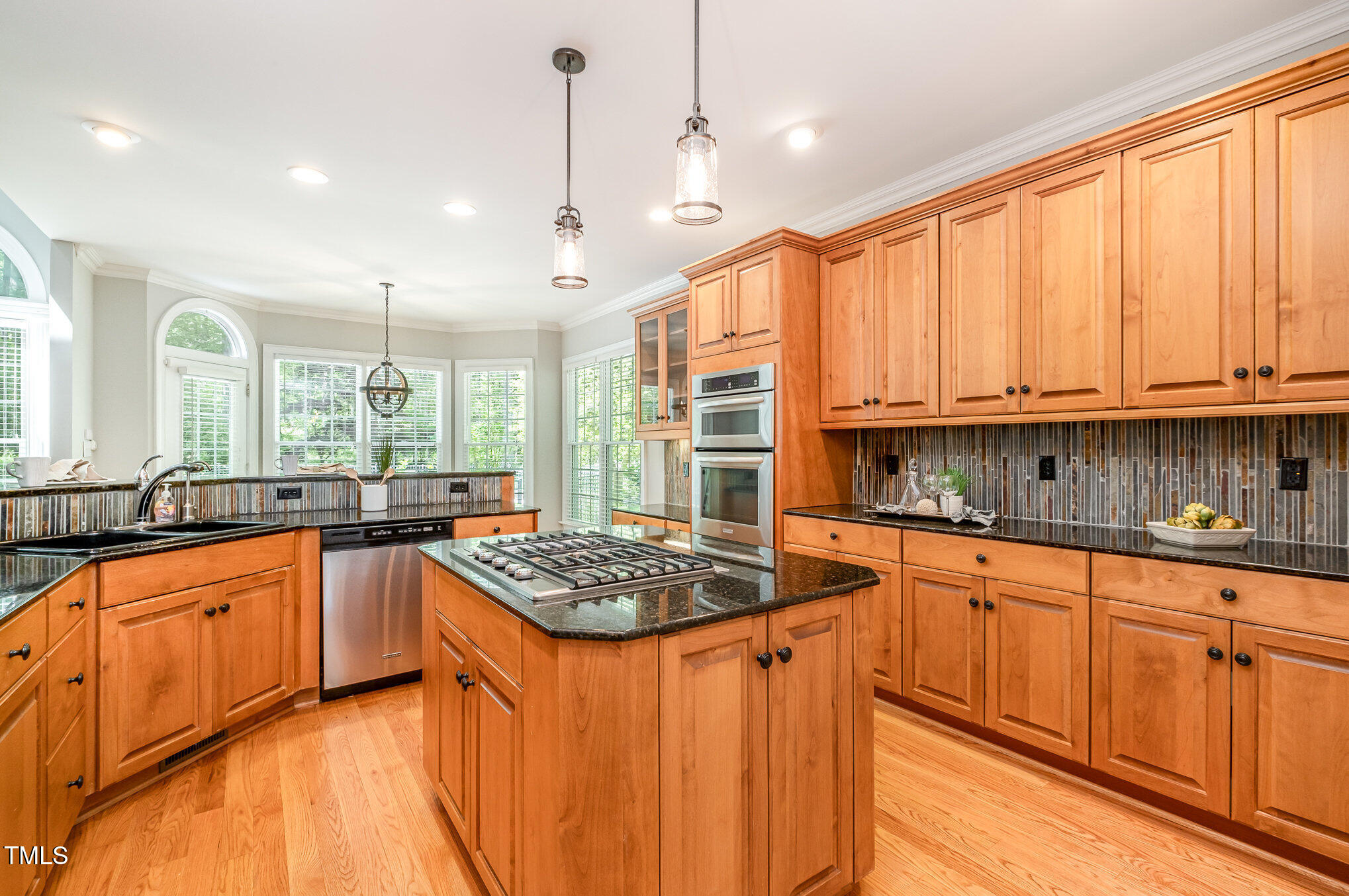 5912 Weather Rock Court Raleigh, NC 27613 - Photo 16 of 50 a kitchen with stainless steel appliances granite countertop a stove a sink dishwasher and a microwave