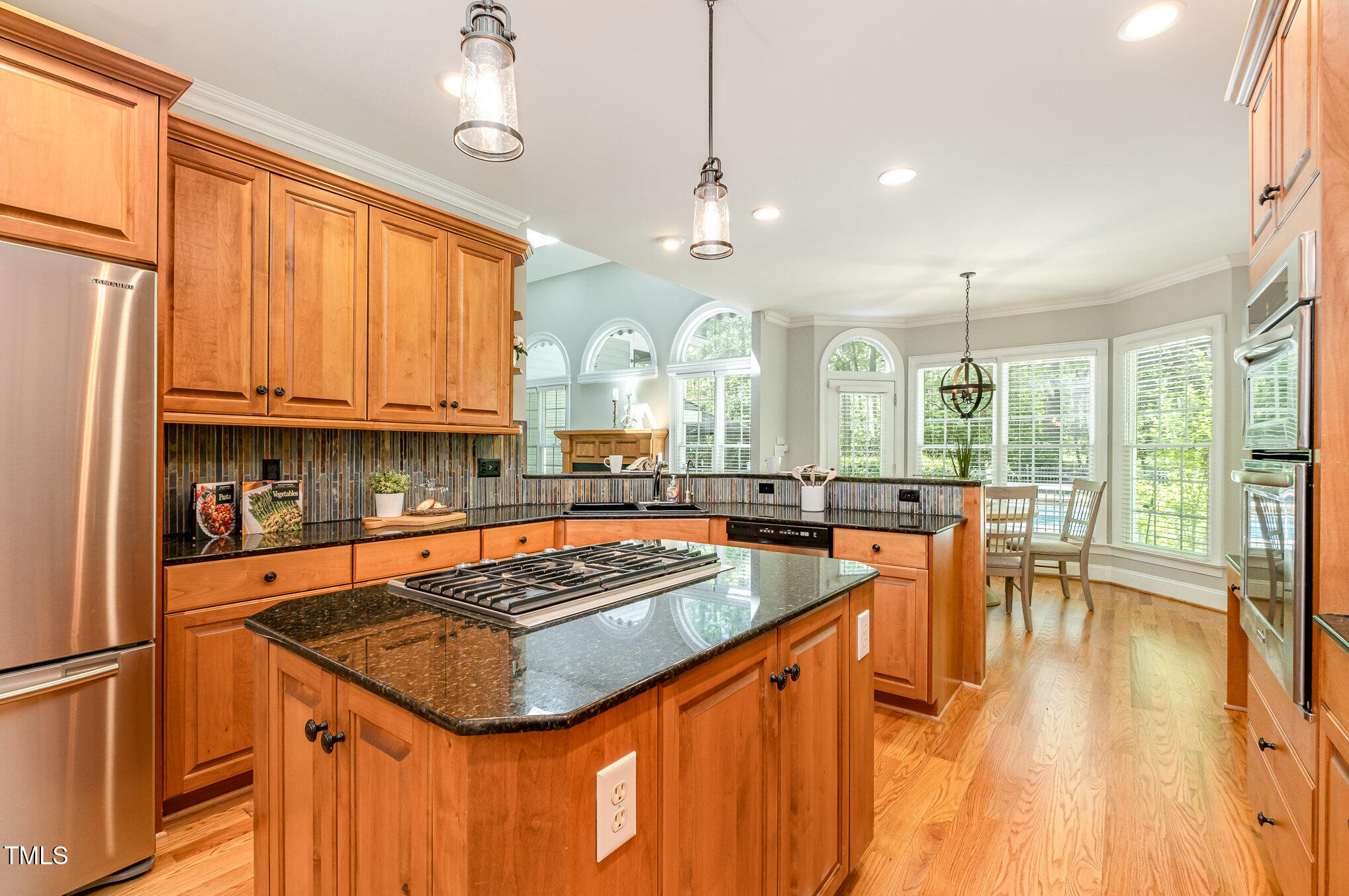 5912 Weather Rock Court Raleigh, NC 27613 - Photo 18 of 50 a kitchen with stainless steel appliances granite countertop a sink a stove and refrigerator