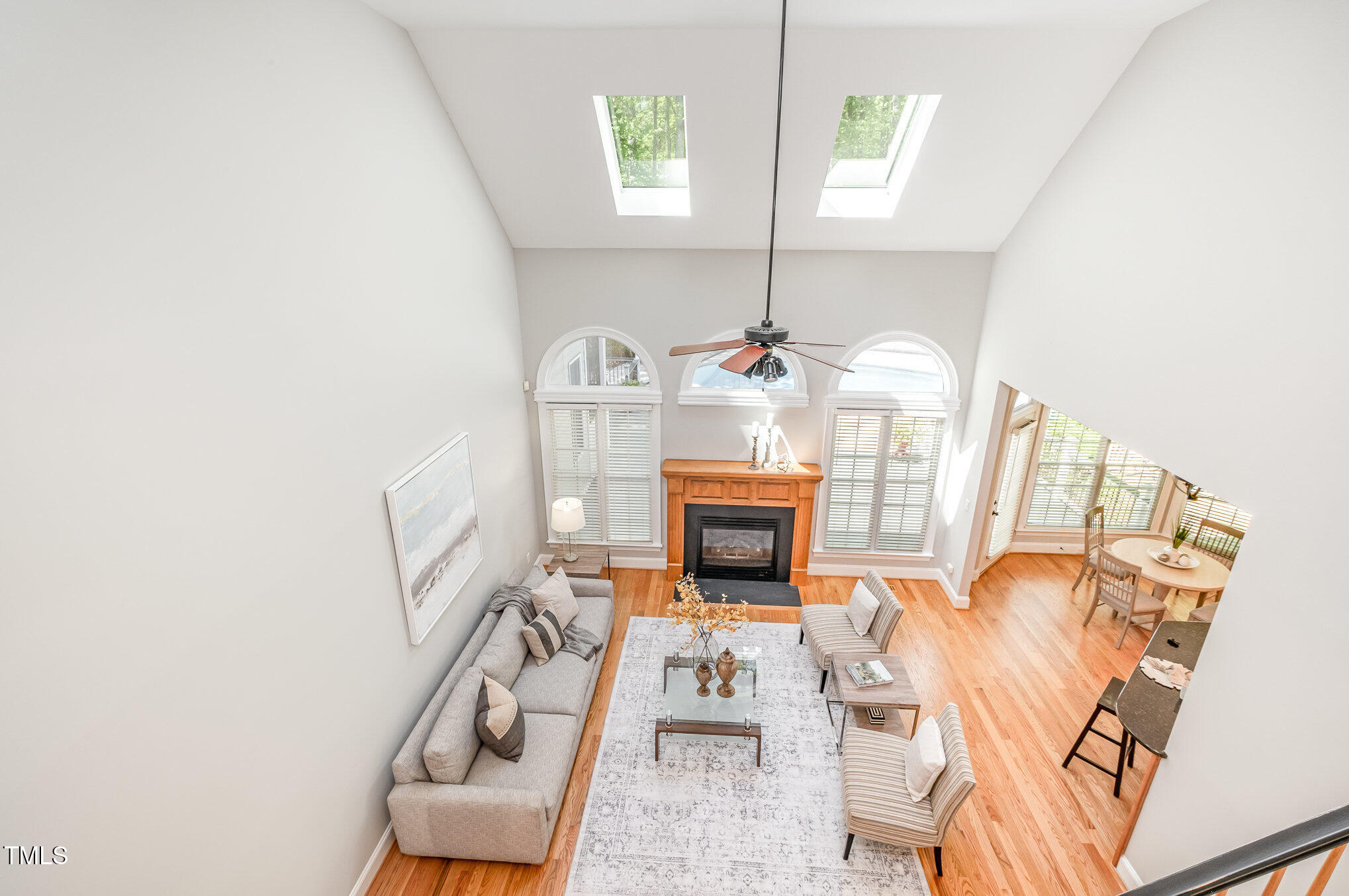 5912 Weather Rock Court Raleigh, NC 27613 - Photo 25 of 50 a living room with furniture a fireplace and a chandelier
