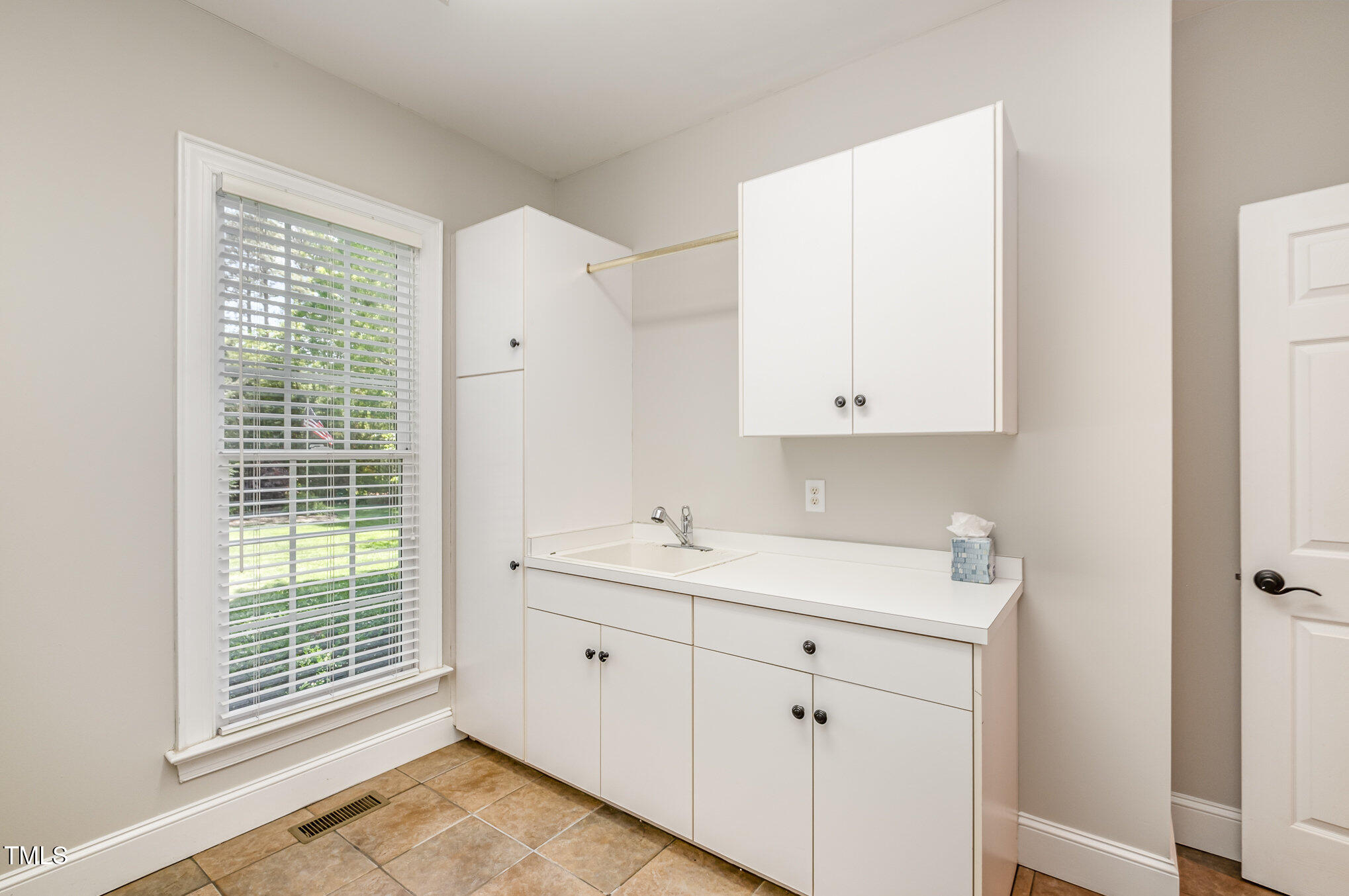 5912 Weather Rock Court Raleigh, NC 27613 - Photo 41 of 50 a bathroom with a sink a toilet and a window