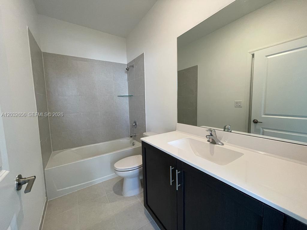10144 Southwest 228th Terrace Miami, FL 33190 - Photo 18 of 23 a bathroom with a sink a toilet and shower