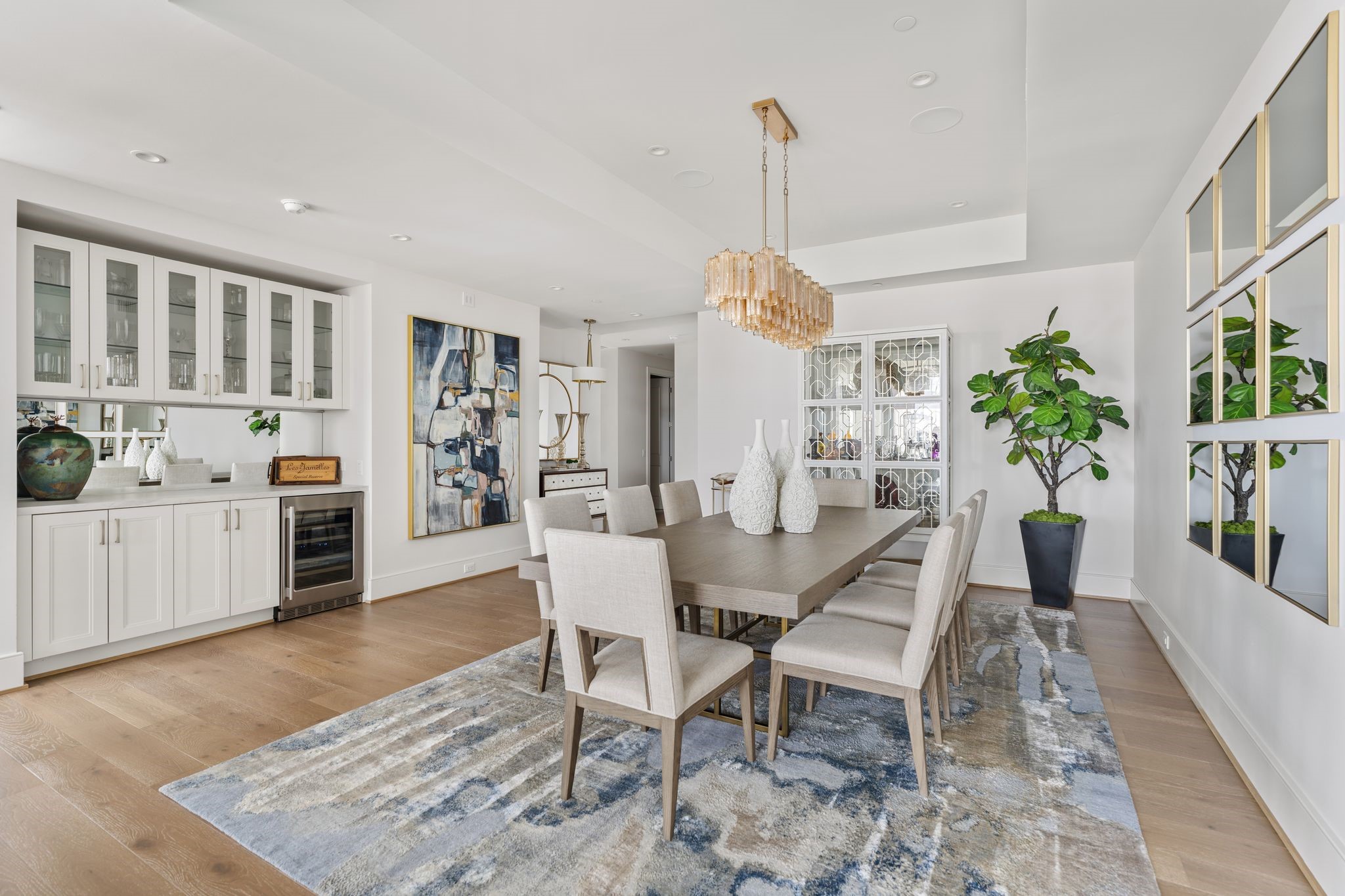 5656 San Felipe Street, Unit 1401 Houston, TX 77056 - Photo 7 of 40 a view of a dining room and livingroom with furniture wooden floor a chandelier