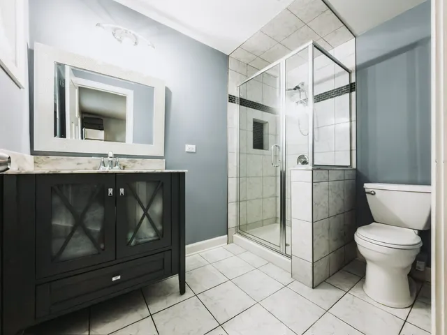 a bathroom with a toilet sink and shower