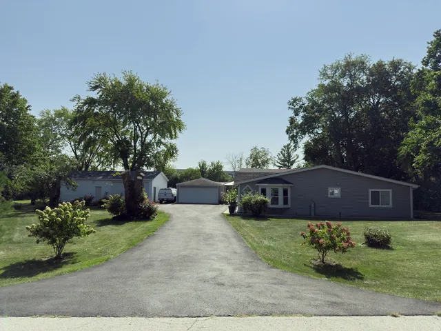a house view with a sitting space and garden