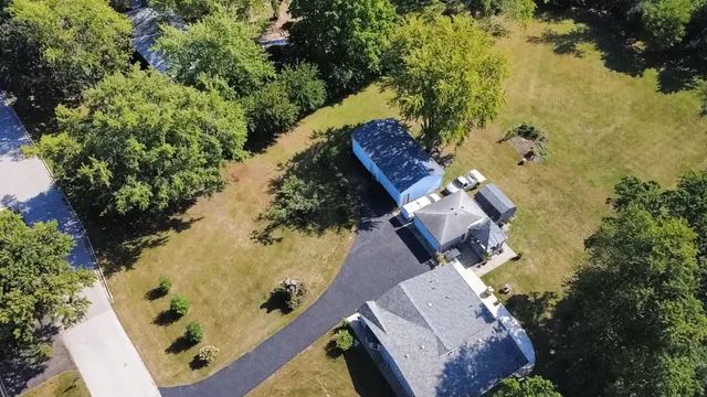 an aerial view of a house with a yard