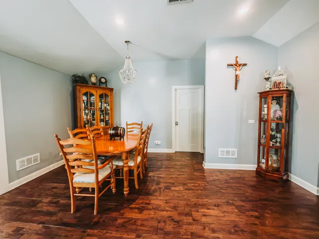 a dining room with furniture and wooden floor