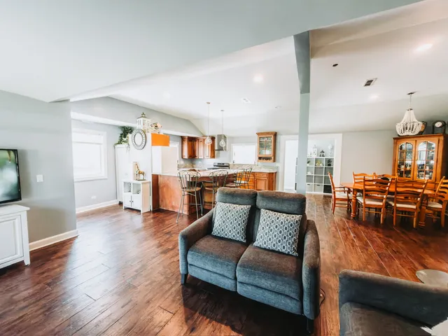 a living room with furniture and kitchen view