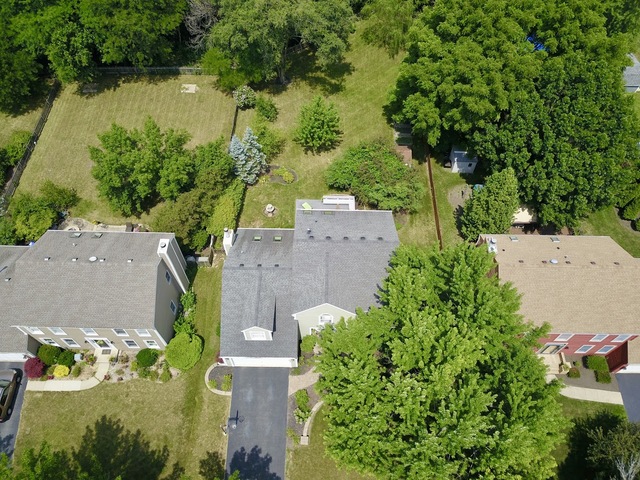 1235 Leverenz Road Naperville, IL 60564 - Photo 2 of 25 an aerial view of a house with a yard and lake view