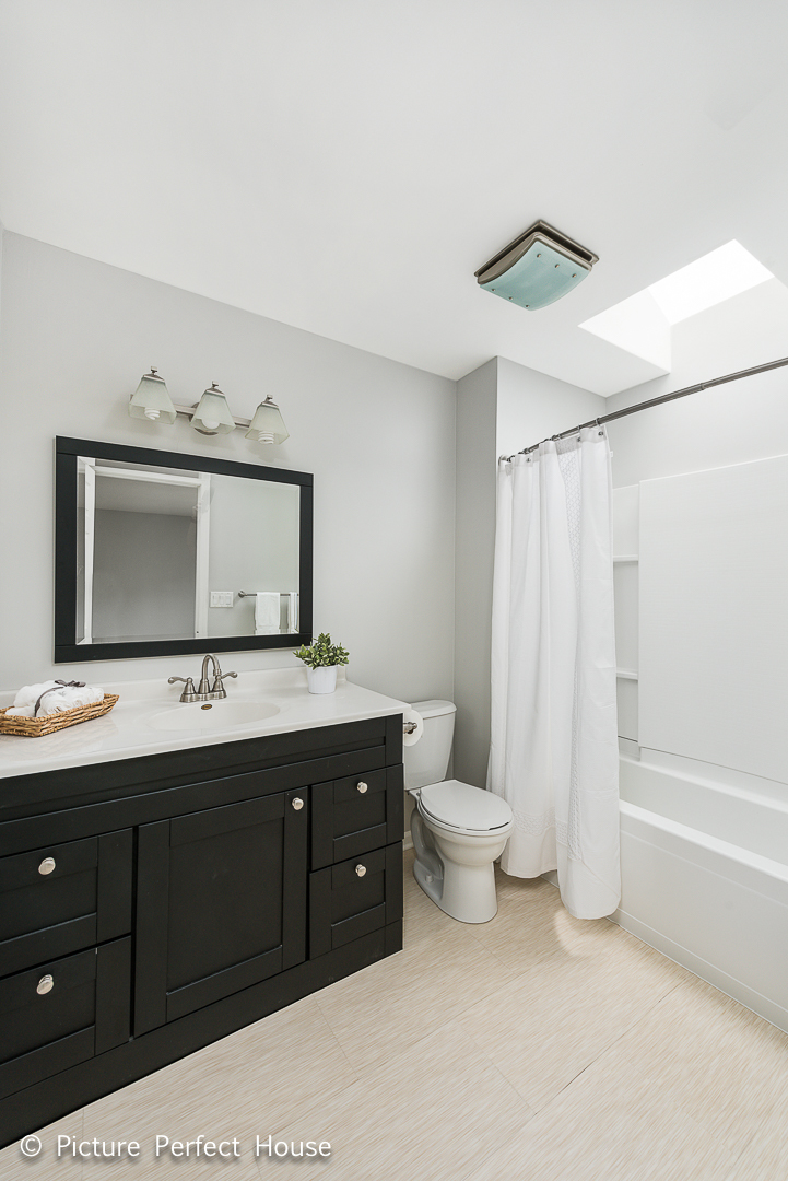 1235 Leverenz Road Naperville, IL 60564 - Photo 13 of 25 a bathroom with a double vanity sink toilet and mirror