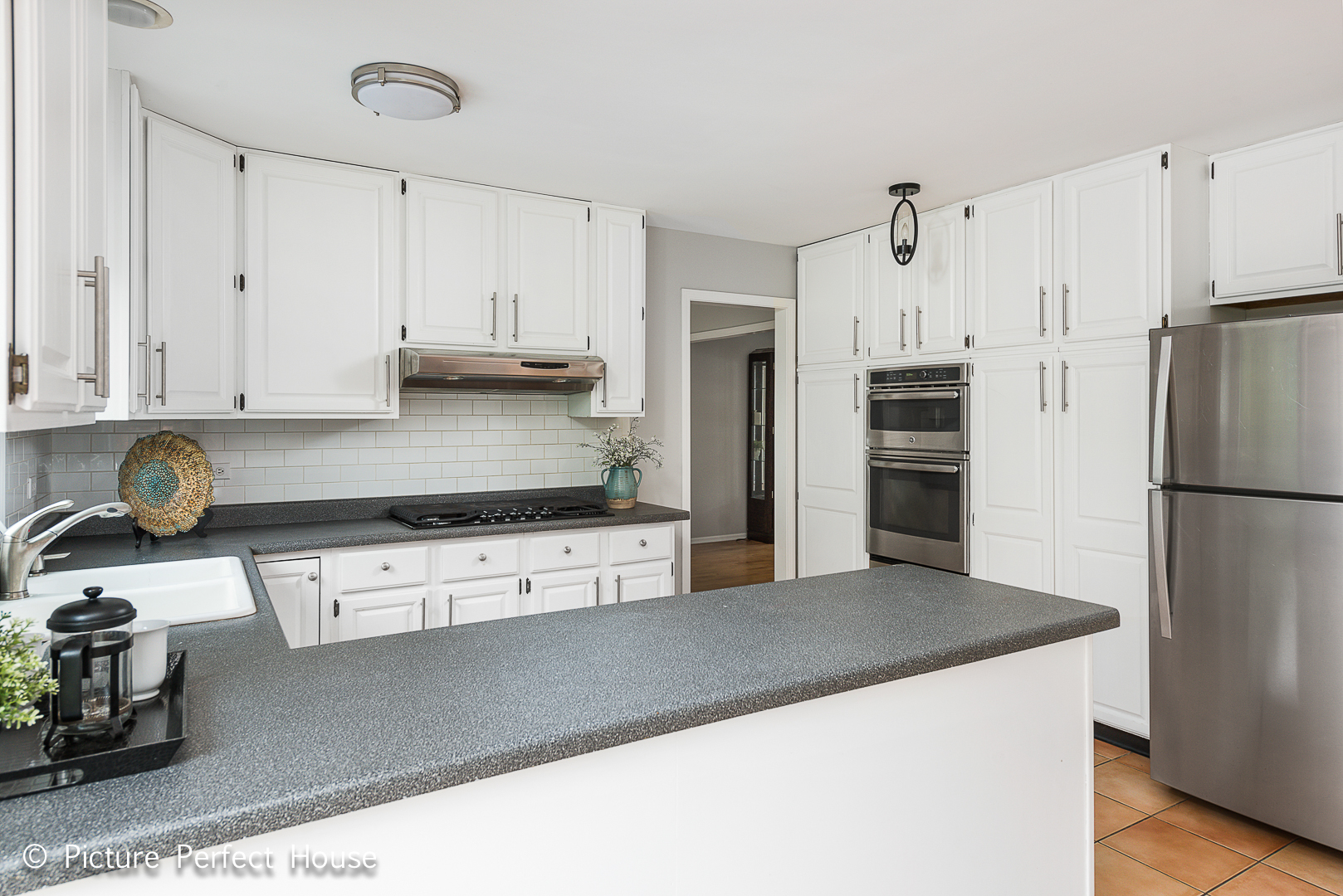 1235 Leverenz Road Naperville, IL 60564 - Photo 4 of 25 a kitchen with stainless steel appliances a refrigerator sink and white cabinets