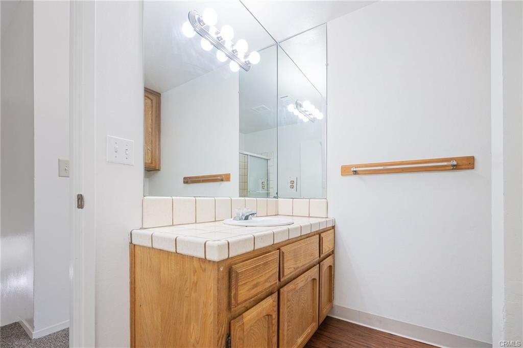 49400 River Park Road, Unit 17 Oakhurst, CA 93644 - Photo 24 of 34 a bathroom with a sink and a mirror