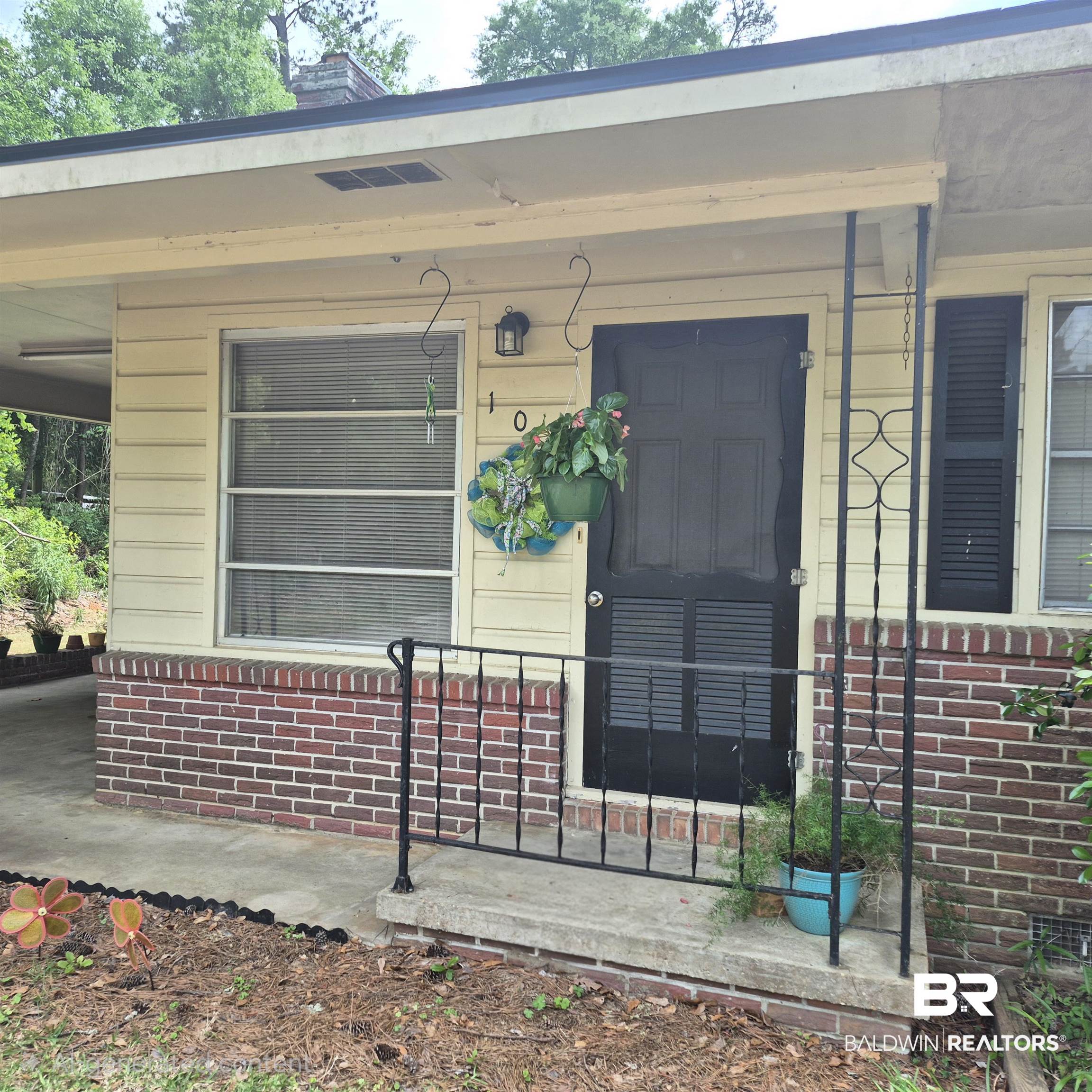 108 Azalea Street Evergreen, AL 36401 - Photo 3 of 19 Front facade featuring horizontal siding and brick accents