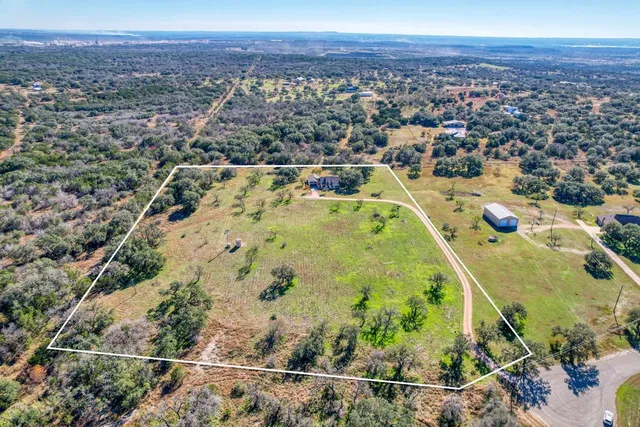 an aerial view of residential houses and outdoor space