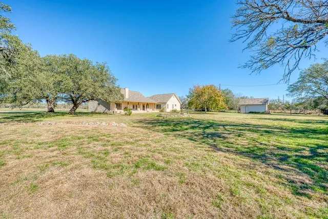 a view of a field with an trees