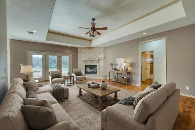a living room with furniture ceiling fan and a rug