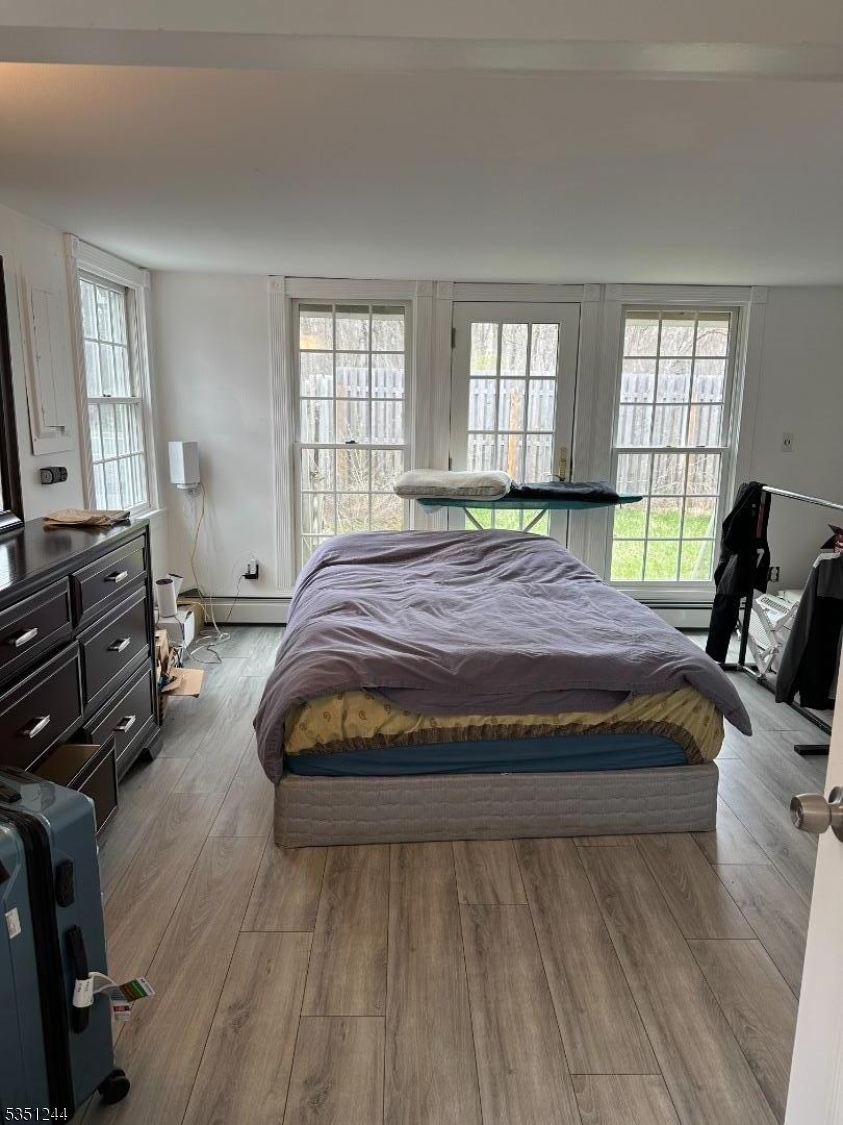 213 Liberty Corner Road Bernards, NJ 07931 - Photo 13 of 24 a bedroom with a bed and wooden floor