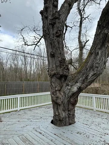 a porch with a bench next to a yard
