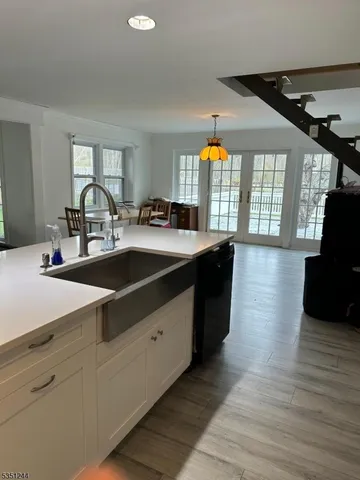 a kitchen with sink cabinets and wooden floor