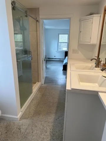 a bathroom with a bathtub and a shower