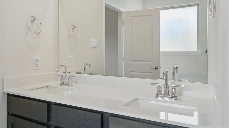 4162 Waldron Trail Forney, TX 75126 - Photo 18 of 29 Double vanity with integrated rectangular sinks, white countertop, and chrome fixtures