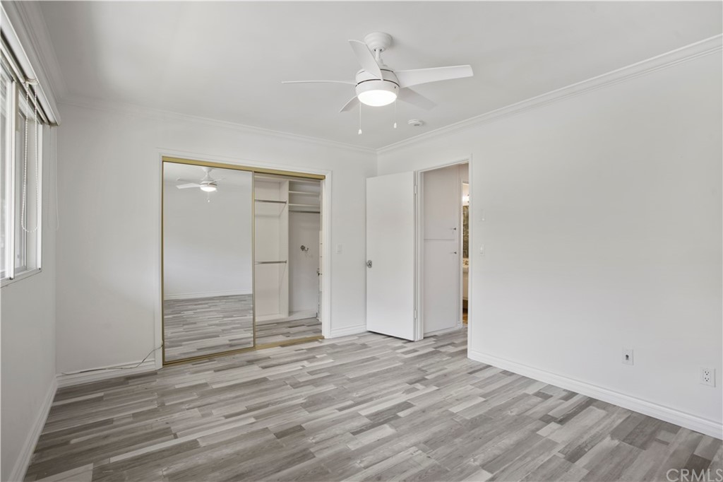3 Blue Lagoon Laguna Beach, CA 92651 - Photo 23 of 32 an empty room with wooden floor and ceiling fan