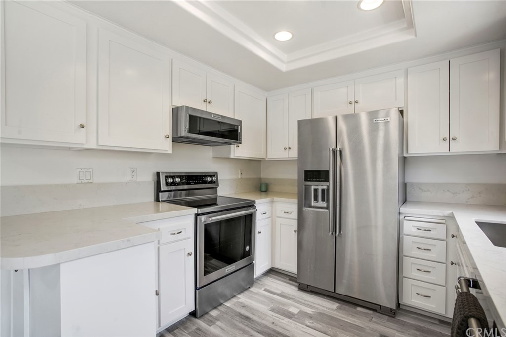 3 Blue Lagoon Laguna Beach, CA 92651 - Photo 6 of 32 a kitchen with stainless steel appliances a stove a refrigerator and a cabinets