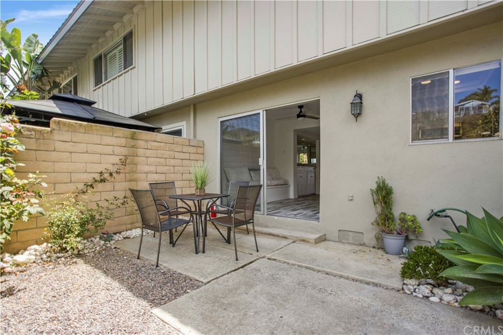 3 Blue Lagoon Laguna Beach, CA 92651 - Photo 10 of 32 a patio with table and chairs and potted plants