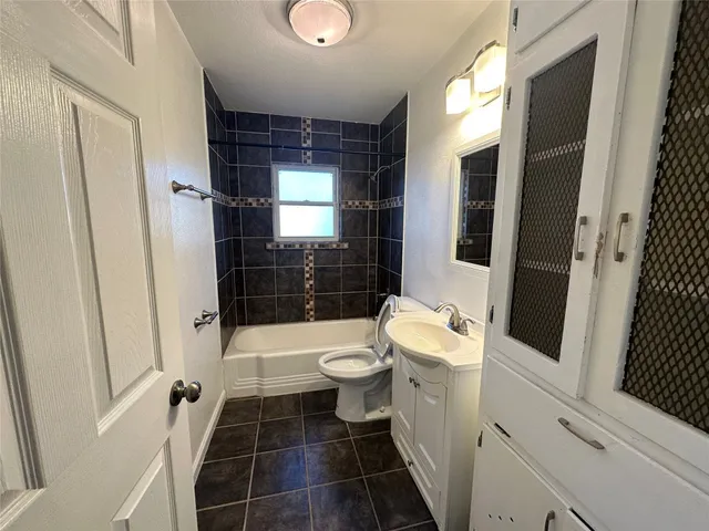 a bathroom with a toilet a sink and a shower