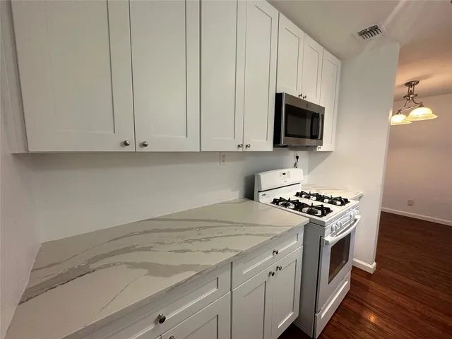 a kitchen with a stove and a microwave