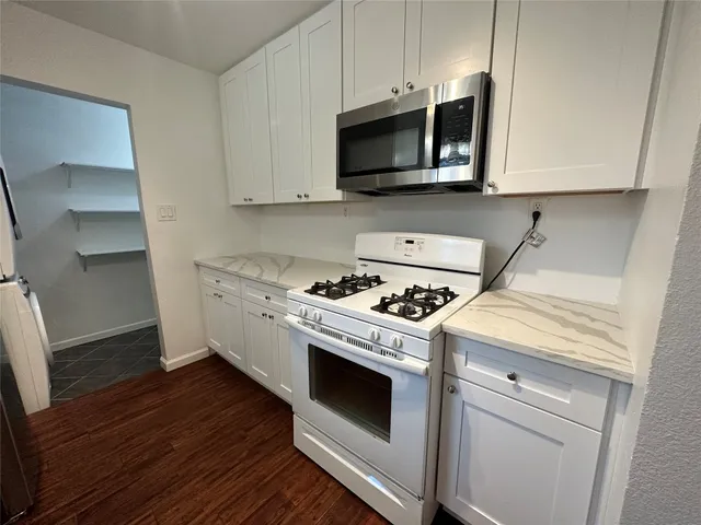 a kitchen with a stove and a microwave