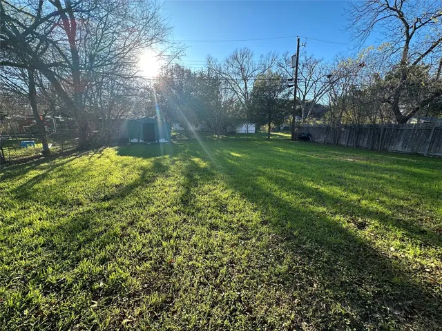 a view of a backyard with large trees
