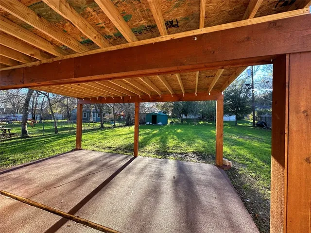 a view of a backyard with wooden fence