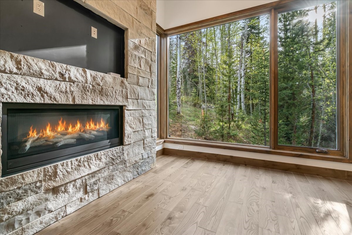 1615 Golden Eagle Road Silverthorne, CO 80498 - Photo 25 of 47 a living room with a fireplace with flat screen tv