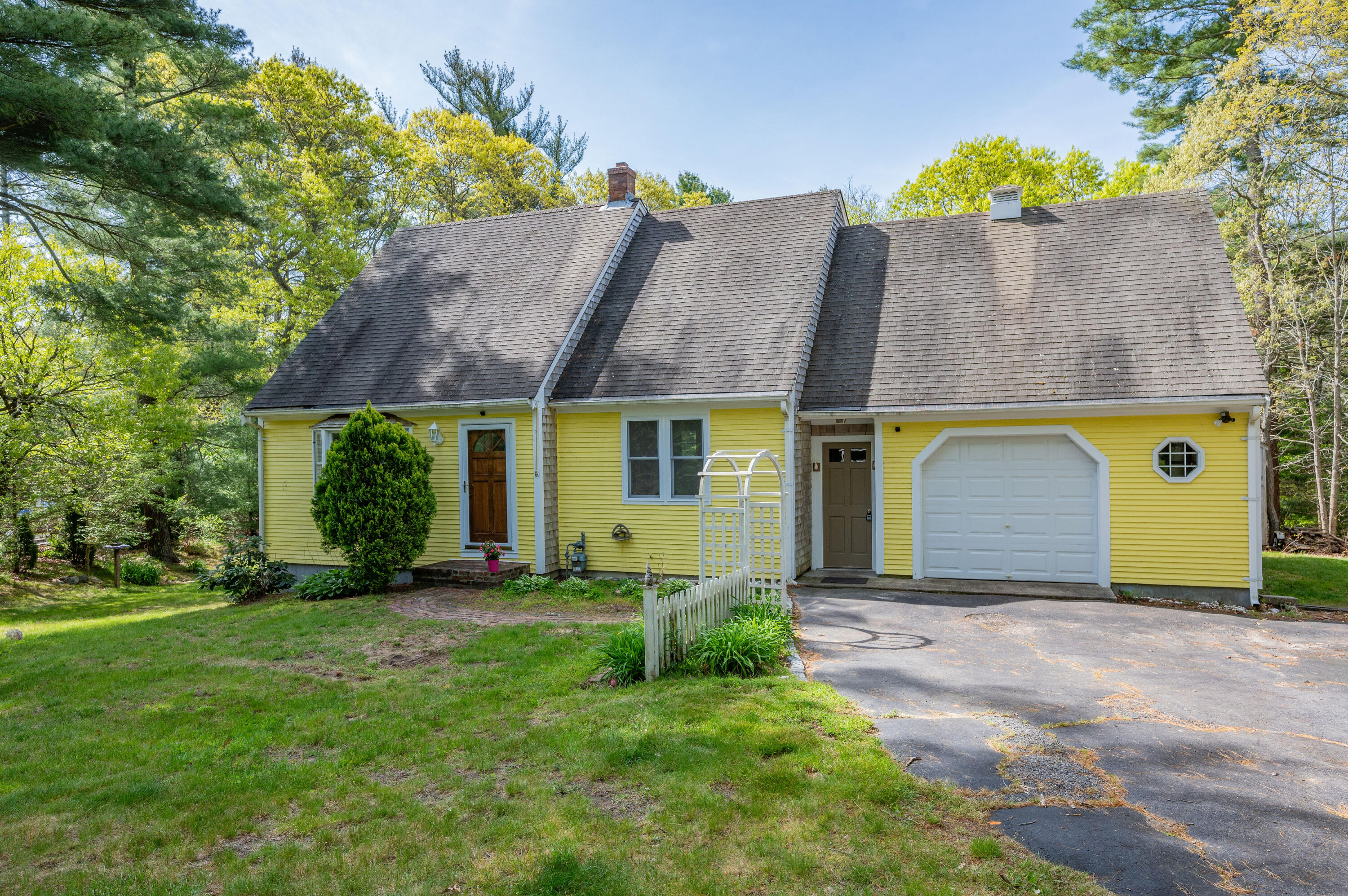 a view of a house with a yard and a garage