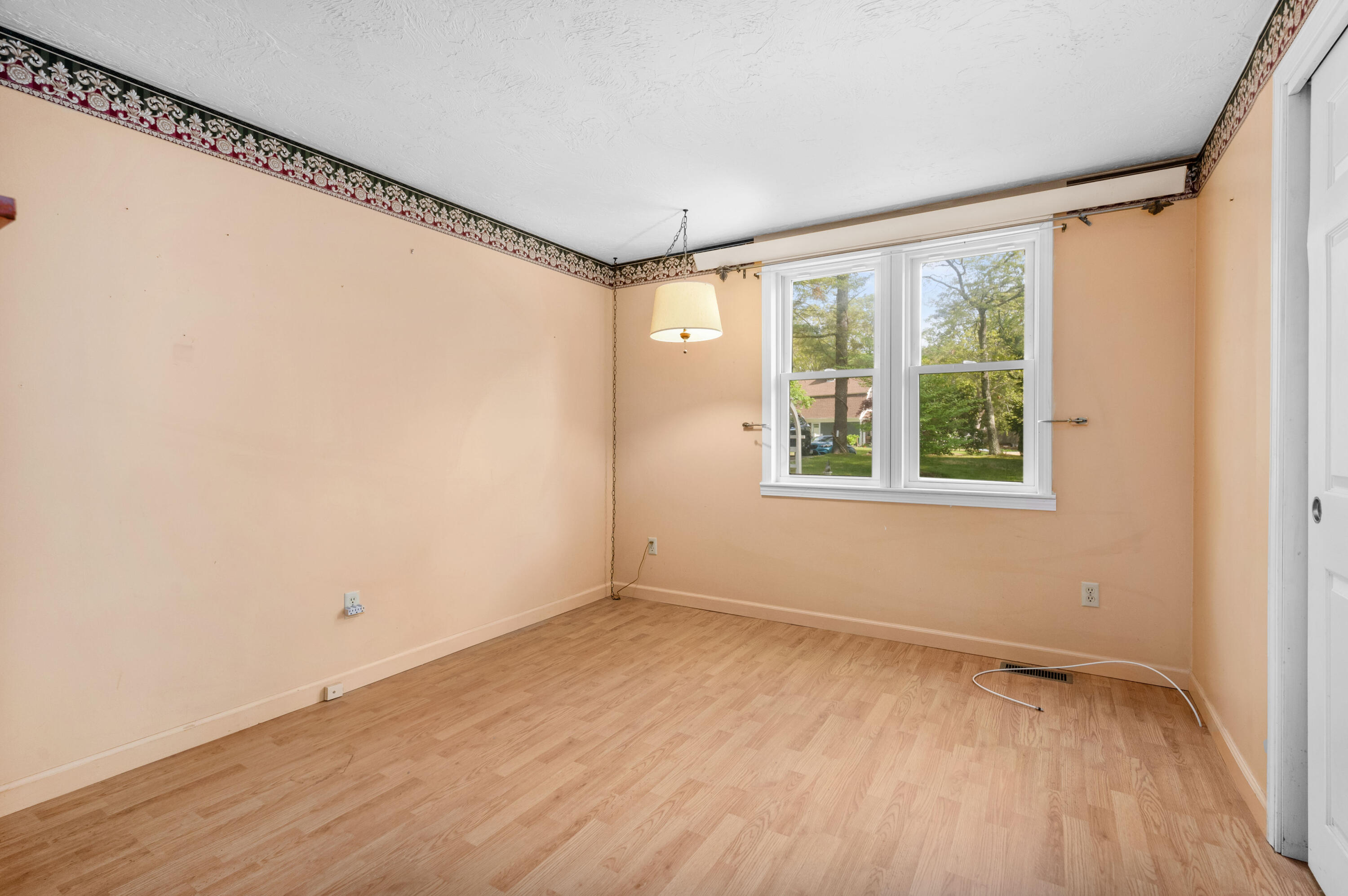 80 J B Drive Marstons Mills, MA 02648 - Photo 9 of 27 a view of an empty room with a window and wooden floor