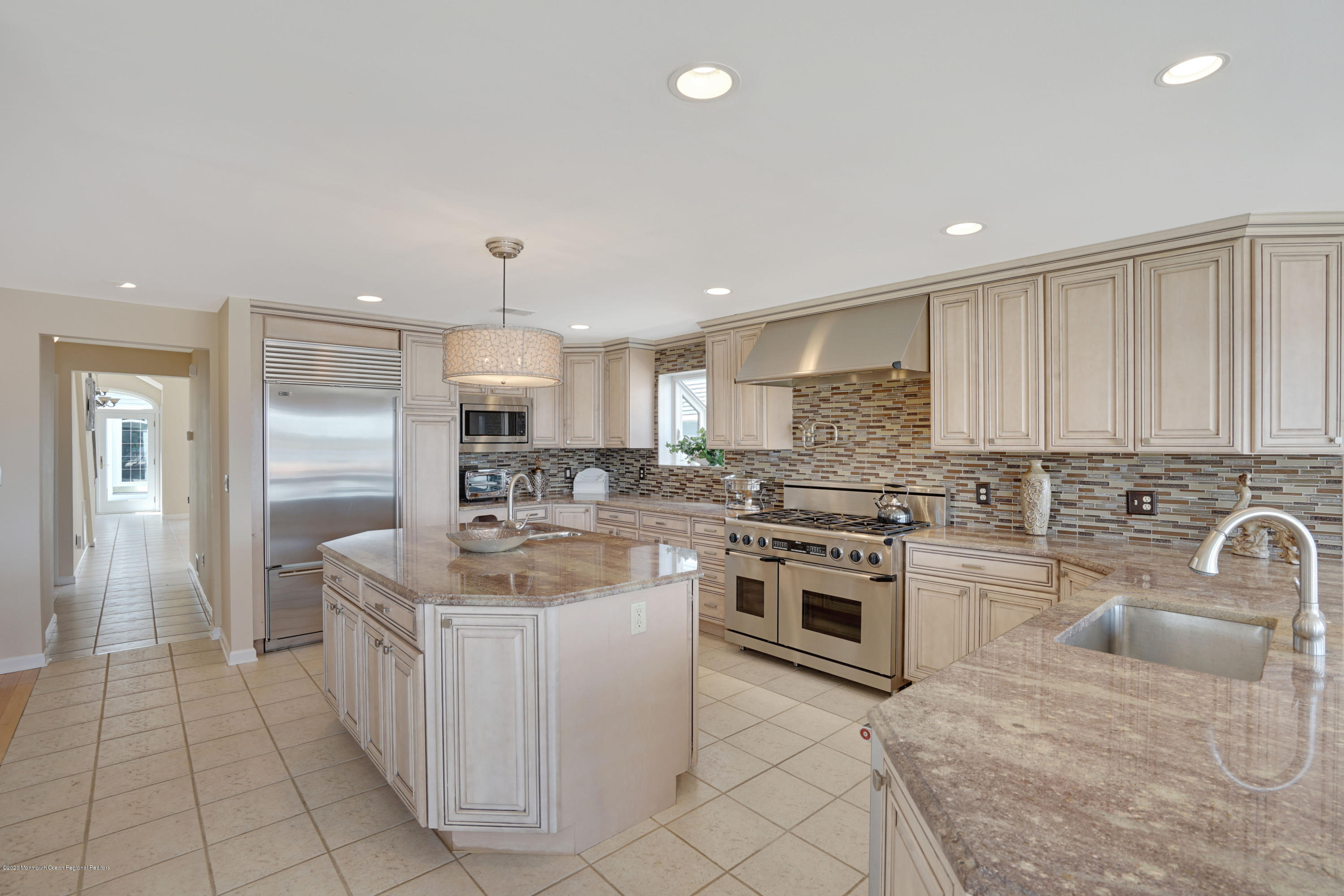 11 Metedeconk Road Brick, NJ 08723 - Photo 20 of 99 a kitchen with stainless steel appliances granite countertop a stove top oven a sink and a refrigerator