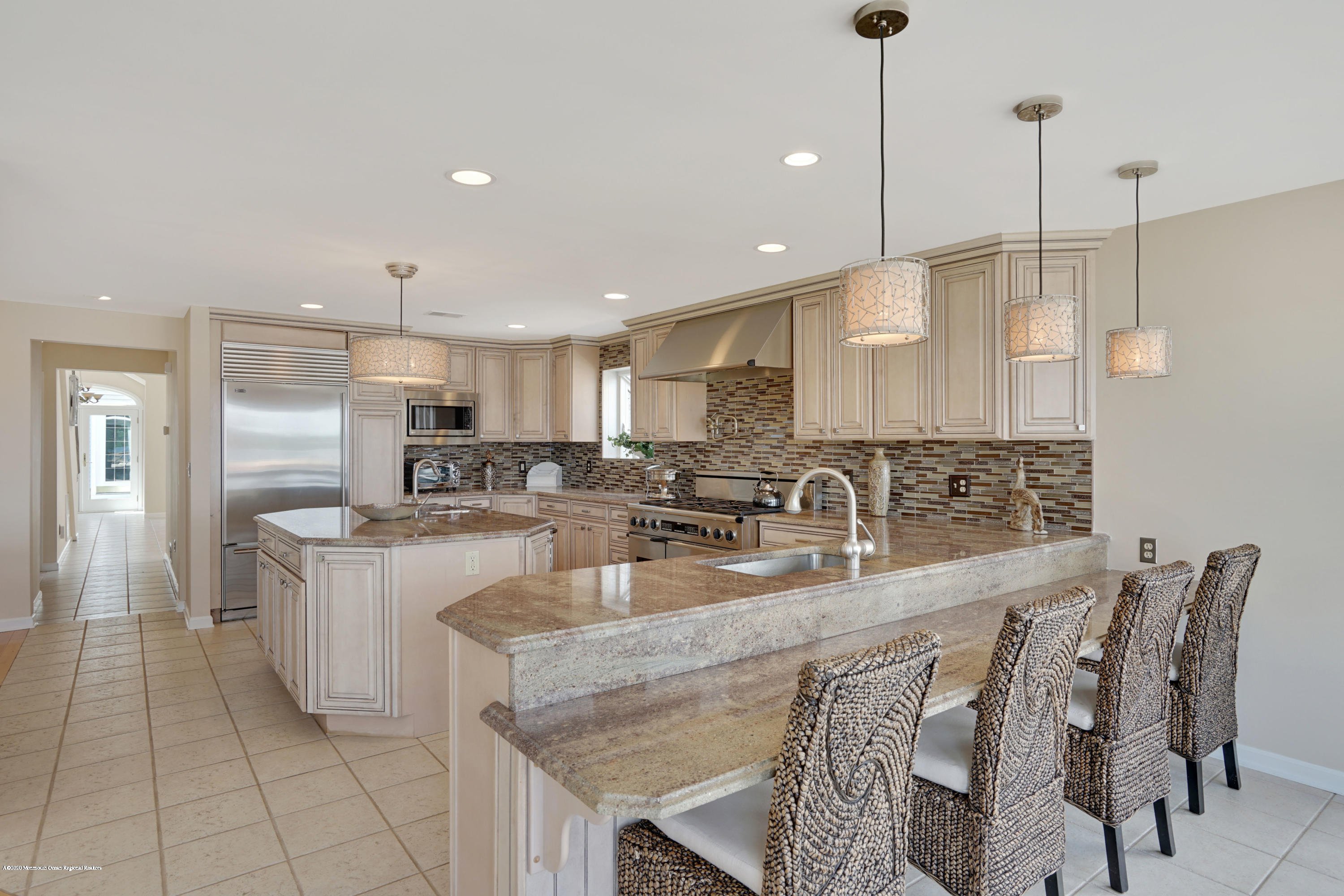 11 Metedeconk Road Brick, NJ 08723 - Photo 25 of 99 a kitchen with stainless steel appliances granite countertop a kitchen island a stove a sink a dining table and chairs