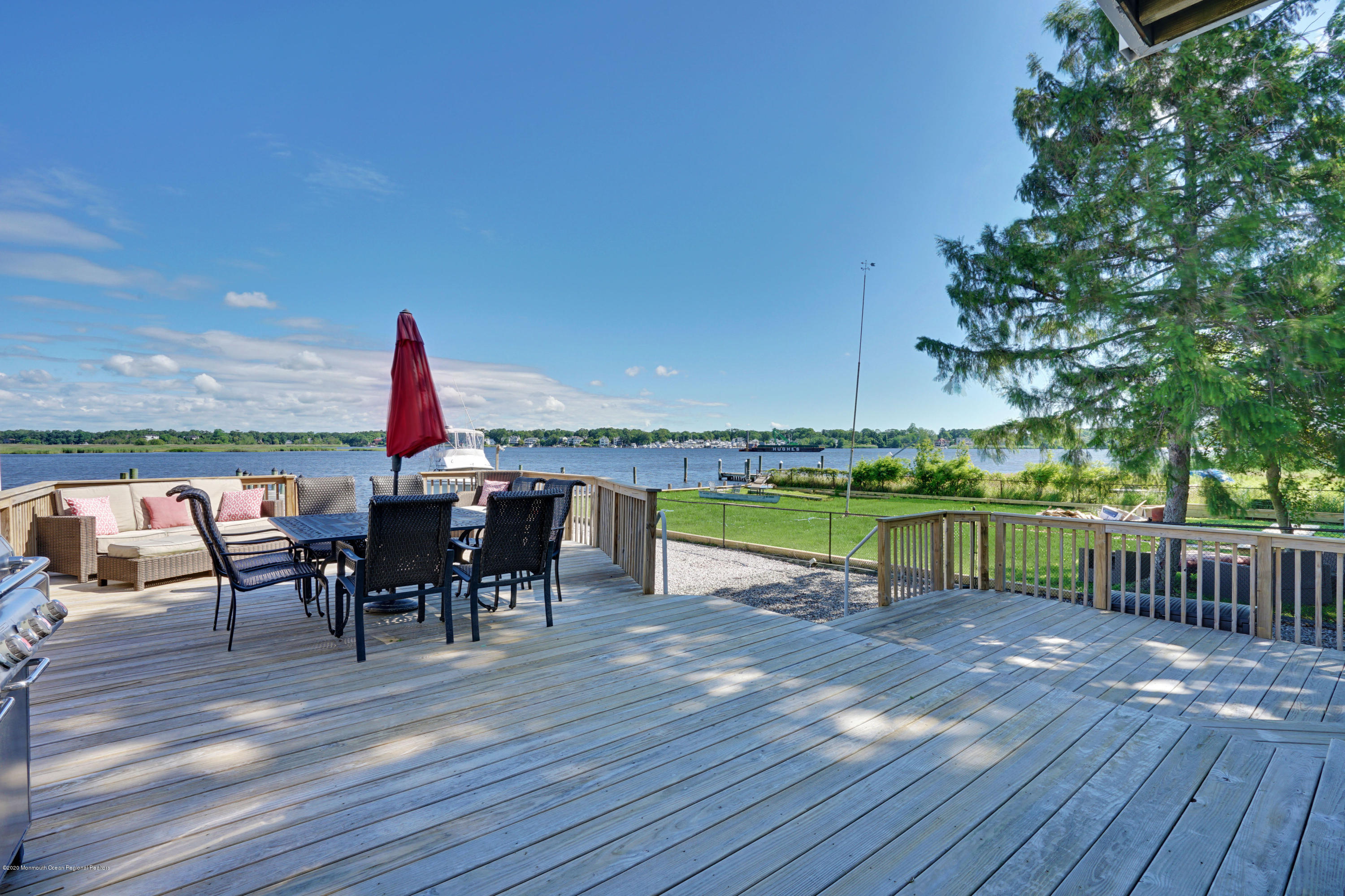 11 Metedeconk Road Brick, NJ 08723 - Photo 44 of 99 a view of a roof deck with table and chairs a barbeque with wooden floor and fence