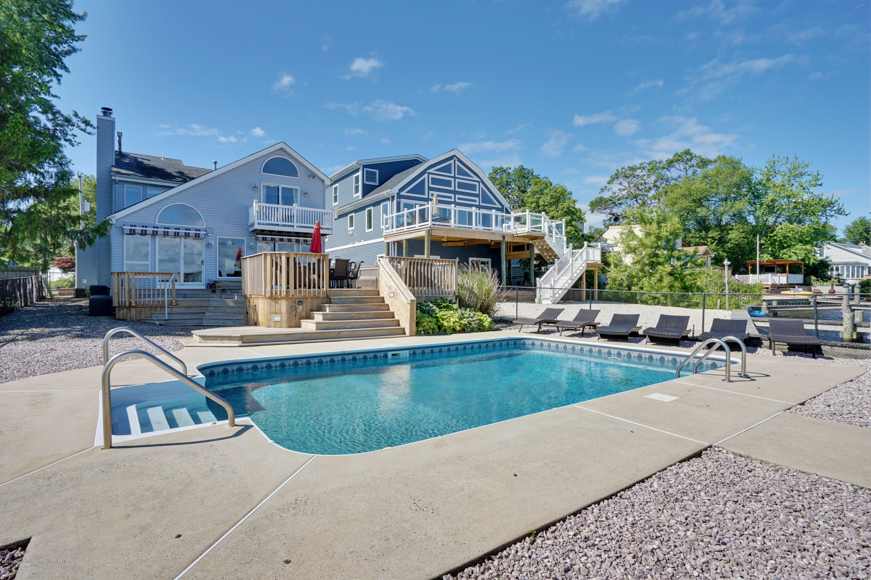 11 Metedeconk Road Brick, NJ 08723 - Photo 48 of 99 a view of a house with pool lawn chairs and a barbeque