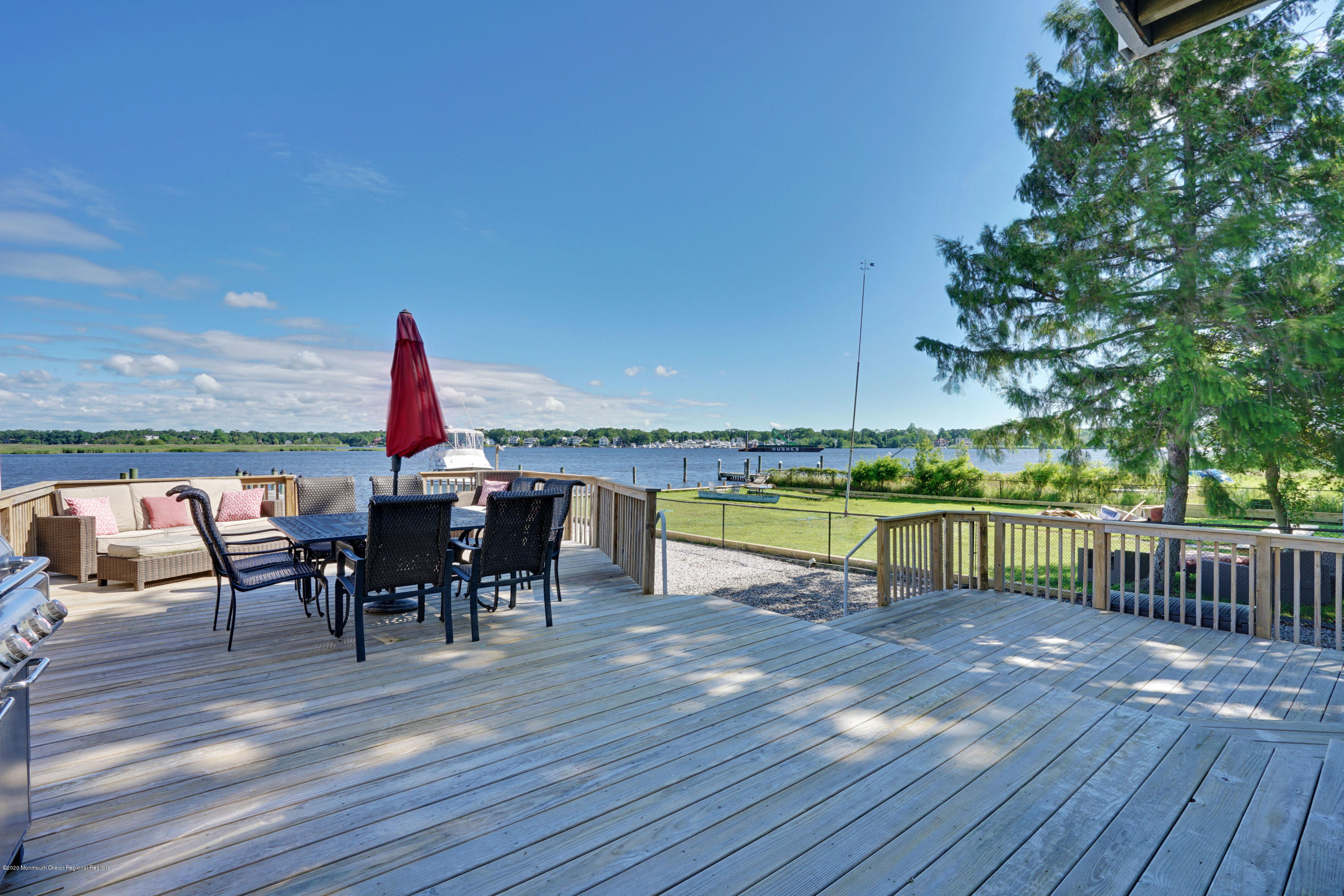 11 Metedeconk Road Brick, NJ 08723 - Photo 70 of 99 a view of a roof deck with table and chairs a barbeque with wooden floor and fence